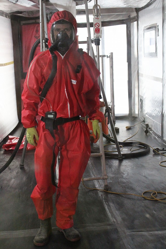 Asbestos operatives inside carrying out a personal air monitoring test