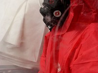 Asbestos operative with full face respiratory equipment RPE