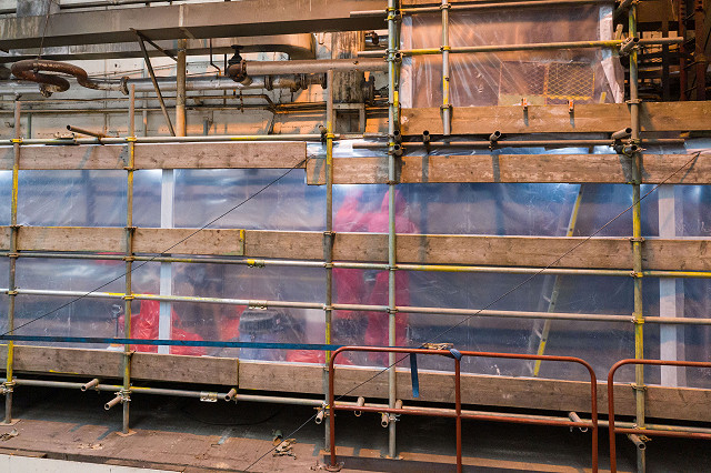 Asbestos Operatives working inside enclosure cutting pipe work